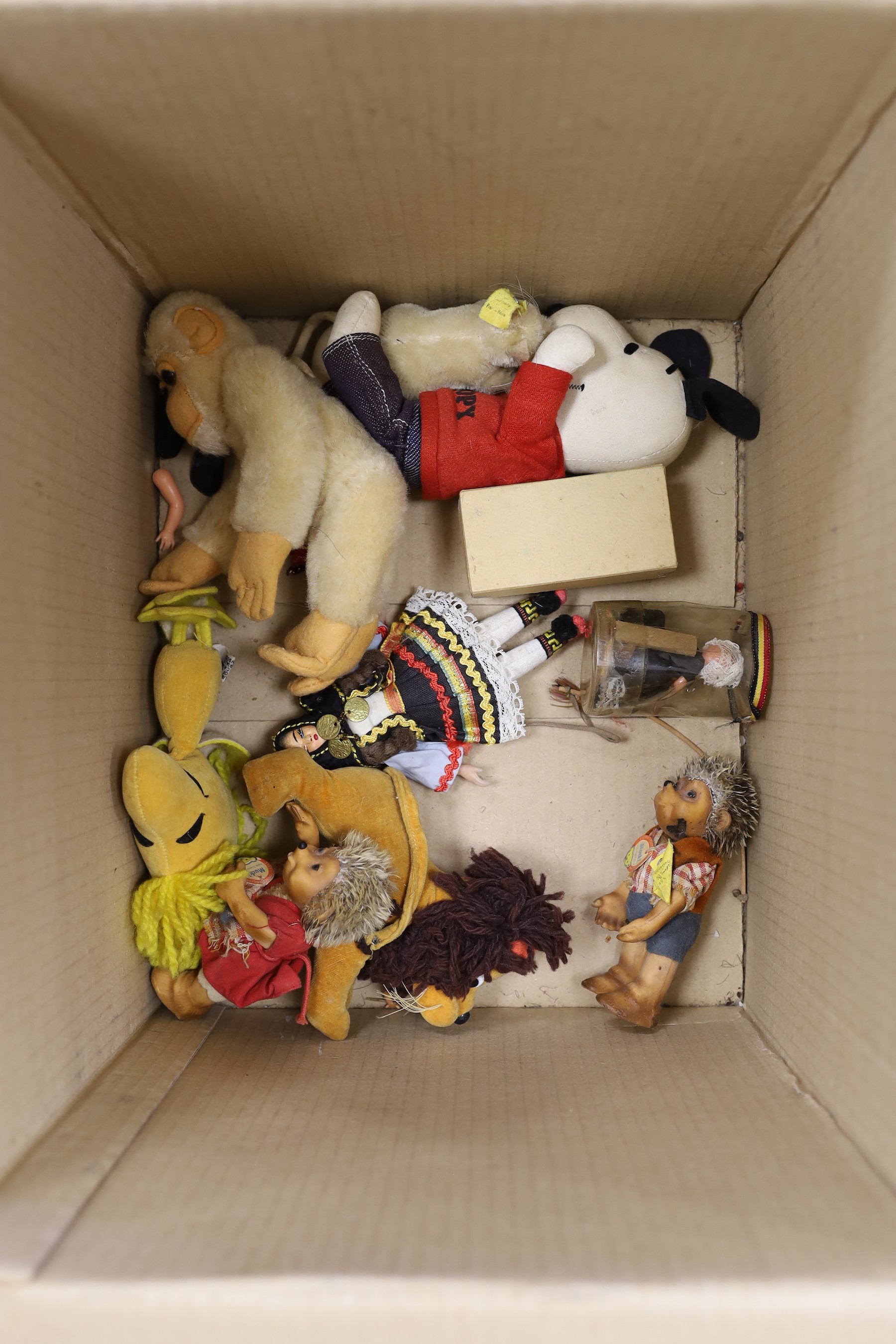 An assortment of soft toys, including Steiff and two dolls